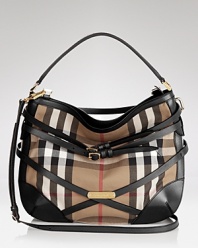 Belted details add equestrian charm to this Burberry hobo, iconic in the brand's signature check print.
