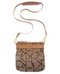Signature jacquard fabric and supple leather trim create a contrasting colorblock effect on this compact, crossbody design by Calvin Klein. Discrete gold links, buckles and multi-purpose slip pockets make this the go-to bag for any occasion.