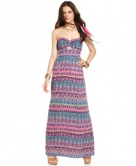 Meet your summer closet's new bestie! From the rich, cultural print to the front and back cutouts, this strapless maxi dress from Angie nails carefree street style!