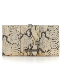 An eye-catching design from Kenneth Cole Reaction, featuring a fun python print and sleek metallic accents. Looks fabulous with any little black dress, or throw it in your bag and use as an oversized wallet.