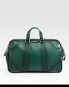 Green hand-stained leather duffel with perforated trim detail.Top zip closureLeather top handleInside pocket with a Gucci crest zipperFive metal feetVelvet Diamante liningLeather20.5W x 12.2H x 8DMade in Italy