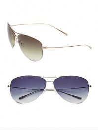 Sporty, double-bridge, semi-rimless titanium sunglass is crafted with lightweight titanium temples and metal front in a classic aviator shape. Available in gold with olive gradient lens and silver with grey gradient lens. Silicone nose pads Temple tips provide additional comfort and fit Gradient lenses are a six-base lens curve 100% UV protection Imported