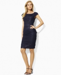 Finished with a boat neckline and shirring down the sides for a flattering, body-contouring fit, Lauren by Ralph Lauren's petite sequined dress with a mesh overlay exudes chic, sexy appeal.