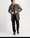 Double-breasted coat with trench-style aesthetics, featuring shoulder epaulettes and buckle closure at the collar, finished in a burnished leather, for an uptown meets downtown feel.Double-breasted button-frontShoulder epaulettesBelted waistRear ventFully linedAbout 36 from shoulder to hemLeatherDry cleanImported