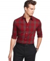 Macy's holiday exclusive! Crafted in a cool heathered plaid, this shirt from Calvin Klein will be your new seasonal standard.
