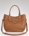 Tory Burch's hobo enlivens classic leather her signature stamp and a must-have hue. From workday to weekend, this versatile bag will make closet staples pop.
