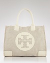 Introduce destination chic into your accessories portfolio with Tory Burch's canvas tote. This logo-stamped bag boasts ample room, making it the ultimate runway-to-resort companion.