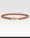 Waist defining and beyond chic, this leather skinny belt is flawlessly complemented by a brass buckle.Brass buckleLeatherLength, 27Width, ½Imported