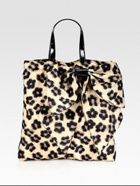 A roomy shape of sturdy nylon in a sexy leopard print, complete with a front bow and patent leather top handles. Double patent leather top handles, 6½ dropMagnetic snap closureOne inside zip pocketCotton lining13½W X 14½H X 1¾DMade in Italy