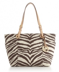 Let your hair down and take a walk on the wild side of designer fashion with this untamed design by MICHAEL Michael Kors. A tiger print exterior features easy access side pockets, 18K gold hardware and a signature charm.