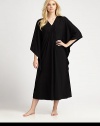 An elegant design with a gathered front and ruffled sides for comfortable, yet sophisticated look. V-neckThree-quarter length kimono sleevesGathered frontRuffled sidesPull-on styleAbout 50 from shoulder to waist67% polyester/33% rayonMachine washImported 