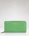 Vivid hues are big news this season. In grassy green, this leather wallet from kate spade new york is a practical way to work the trend.