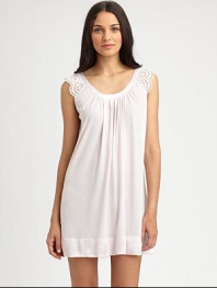 Eyelet cap sleeves with scallop trim make for a truly feminine design, with a wide scoop neckline and front shirring for added drape. Scoopneck with shiny trimEyelet cap sleeves with scallop edgesFront shirringShiny banded hemAbout 34 from shoulder to hem65% polyester/35% rayonMachine washImported