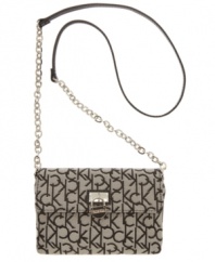 Exude classic signature style with a logo detailed design from Calvin Klein. This petite crossbody style gets a posh upgrade with shiny silvertone chain straps and refined hardware.