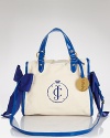 Flaunting cute cobalt bows, Juicy Couture's patent canvas tote is pretty and practical. Sized for your essentials, the color-pop carryall is a dreamy daytime companion.