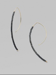 A striking modernist shape strung with oxidized sterling silver beads capped with 14k yellow gold beads.14k yellow gold Oxidized sterling silver Length, about 2¾ Pierced Made in USA