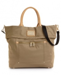 Ready for your next impromptu getaway, this travel-ready tote from Calvin Klein stores all your necessities in oh-so chic style. Polished goldtone hardware and a sleek signature plaque add head turning appeal to this adventure seeking design.