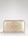 Let Tory Burch's logo-embossed leather wallet stamp your look with the label's signature uptown glamour. In a pinch, tuck it under your arm as a gilded clutch.