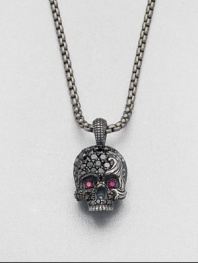 Eye-catching rubies and black diamonds embellish this edgy skull design of sterling silver, suspended from a link chain.Sterling silver/titaniumBlack diamond/rubyAbout 9 diam.Imported