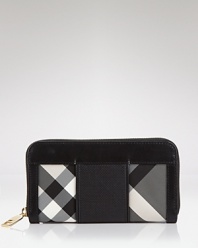 Keep your cash (and card) cache organized with Burberry's black and white check wallet. Take the plaid package into after hours-- it doubles as a preppy chic clutch with a bright sheath and kitten heels.