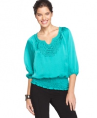 Crochet trim at the neck of Alfani's petite top freshens the look for spring, while a smocked hemline creates a flattering blouson-style silhouette. (Clearance)