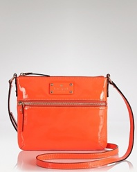 Compact style gets glossy with this coated leather crossbody bag from kate spade new york. Sized to slip across the body, this bag is a small way to add major shine.