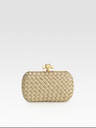 This petite design features goldtone mesh in an elegant woven pattern and an unique knot detailed closure.Top clasp closureSuede lining7¼W X 4¼H X ¾DMade in Italy