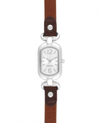 Petite with subtle elegance, by Nine West. Watch crafted of brown leather strap and oval silver tone mixed metal case. Silver tone dial features tonal applied stick indices, numerals at twelve and six o'clock, silver tone hour and minute hands, sweeping second hand and logo at six o'clock. Quartz movement. Limited lifetime warranty.