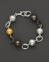 This bracelet from Gurhan is all about texture: hammered white silver and dark silver balloon links with a 24 Kt. yellow gold ball.