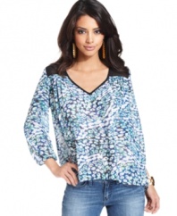 Sheer mesh insets and a colorful, ameba-like print band together seamlessly on this floaty day top from GUESS?.