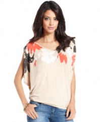 A floral print and flirty draping adds feminine flair to this GUESS? top -- adorable over your fave denim!