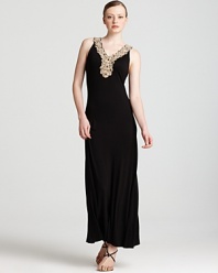 With an embellished neckline and a fluid black silhouette, this Calvin Klein Petites maxi dress will take your look in an elegant direction. Team with sandals and gold accents for goddess-like glamour.