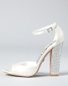A rhinestone-encrusted block heel adds shimmering, on-trend style. From Badgley Mischka.