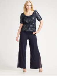 Semi sheer design drapes ever so softly over a sparkly base of sequins. Round neckline Elbow sleeves Concealed back zip Full lining Polyester; dry clean Imported