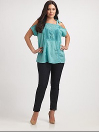 Show a little skin with this unique take on the classic peasant top. This cold-shoulder design features lovely eyelet and self-tie details. Square neckCold shouldersSelf-tiesEyelet and embroidered details at centerAbout 30 from shoulder to hemCottonMachine washImported