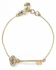Crafted of gold-plated metal with a delicate token, this Juicy Couture bracelet is key to sweet yet simple style.
