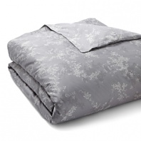 Lilac bouquets in shades of slate grey adorn duvets and shams in this floral Calvin Klein Home collection.
