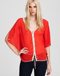 Fashioned in a fiery hue, this GUESS top boasts a billowy silhouette with a lace-up front.