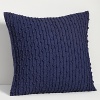 Knotted stripes embellish this decorative pillow.