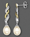 Elegant cultured freshwater pearls (7-9mm) drop elegantly from a setting of 14k white and yellow gold with diamond accents in these sophisticated earrings. Approximate drop: 1-1/4 inches.