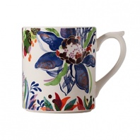 An opulent blue flower blooms from a backdrop of garden delights on the fresh, fun Eden mug from Gien France.