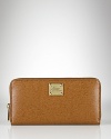 A slim and sleek zip-around wallet crafted in luxe textured leather from Lauren By Ralph Lauren.
