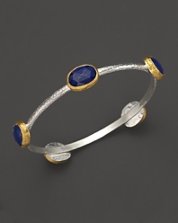 Lapis stations in 24K yellow gold bring vibrant style to this hammered sterling silver bangle from Gurhan.