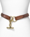 Define your waistline with this woven leather belt from Lauren by Ralph Lauren. Boasting a brass toggle closure, it lends a classic, all-American finish.