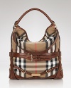 Work Burberry's classic check into your day-to-day look with this slouchy buckle-trimmed canvas hobo. Play up the contemporary edge by teaming it with spray-on leather and a slouchy knits.