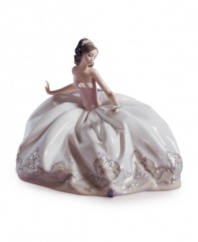 The spring ball awaits this young beauty. Draped in a long, flowing dress and pink wrap, Lladro's graceful porcelain figurine evokes all the excitement and wonder of a first dance.