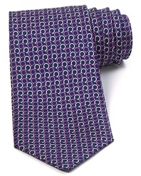 Repeating Gancini logos are rendered in two complementary colors and patterned with a whimsical design on this superior silk tie, offering a bit of refined luxury for the modern man.