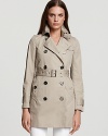 Be timelessly chic in a classic Burberry Brit trench. This sleek belted jacket exudes sophistication day or night. An internal quilted vest lends added warmth.