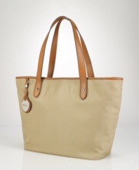Channeling timeless style in a classic silhouette, this chic tote is rendered in lustrous, durable nylon and finished with supple cowhide leather accents for a heritage touch.