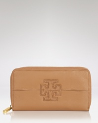 Cash-stashing gets a designer touch with Tory Burch's logo-stamped wallet. In vibrant leather, the luxe little number doubles as a clutch under your arm after hours.